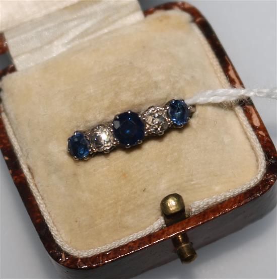 A sapphire and diamond half-hoop ring, the three sapphires and two diamonds in white metal setting, size O.